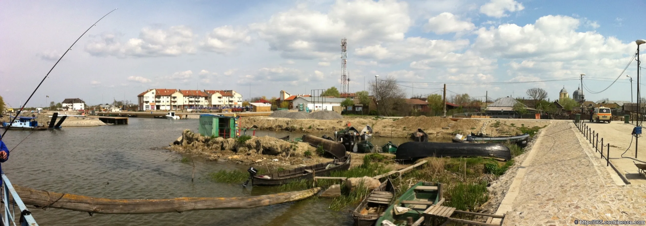 Several fishing boats pulled ashore in a Danube Delta harbor.