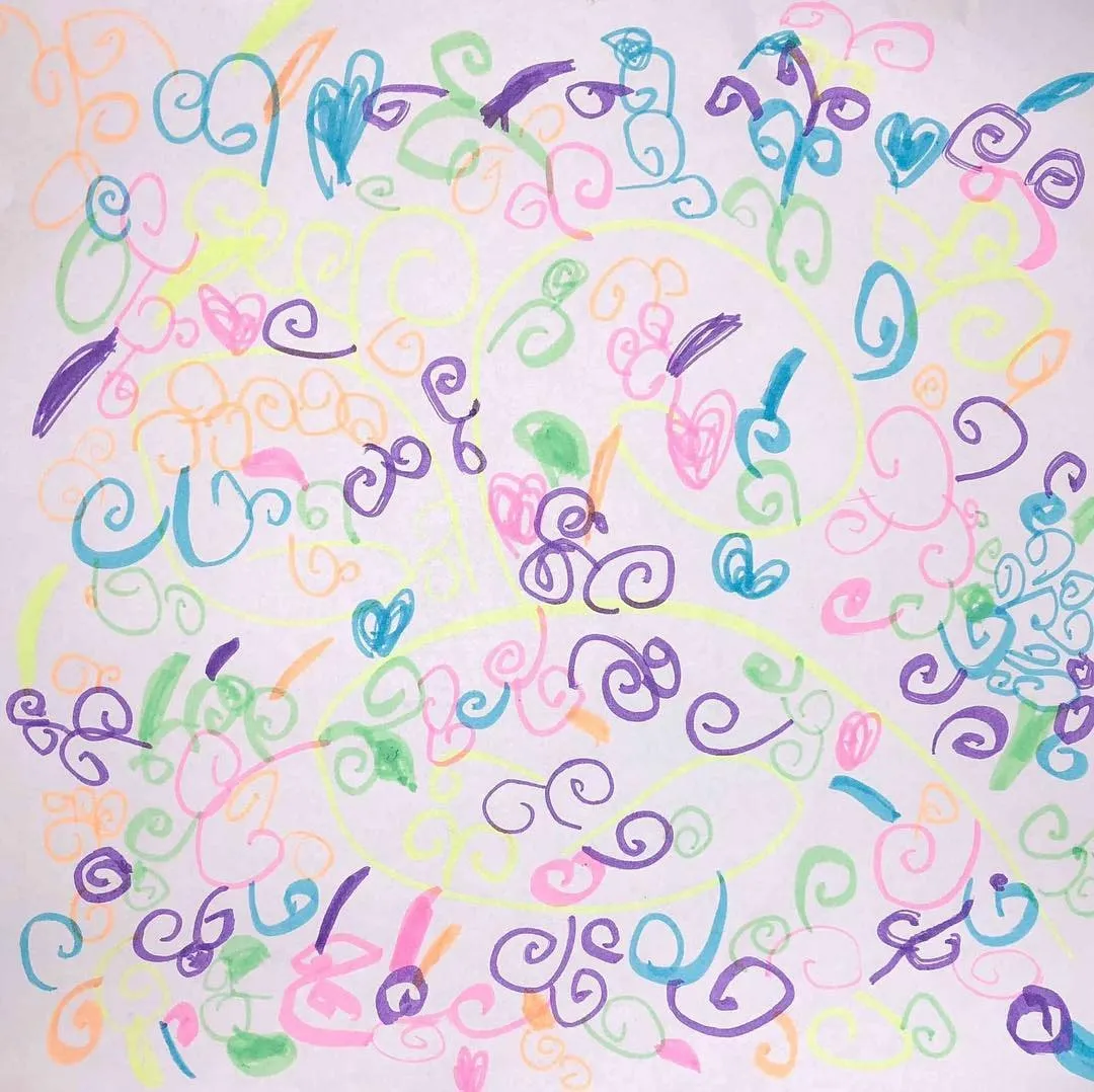 Colorful drawing on white paper featuring spirals, hearts, and abstract shapes in blue, purple, pink, green, and orange.