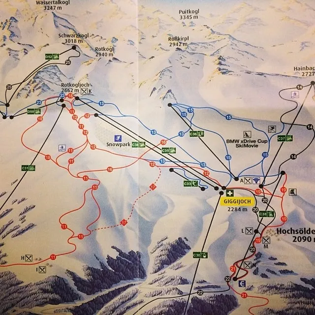 A folded ski resort trail map shows peaks and runs, including Schwarzkogl at 3018 m and Giggijoch.
