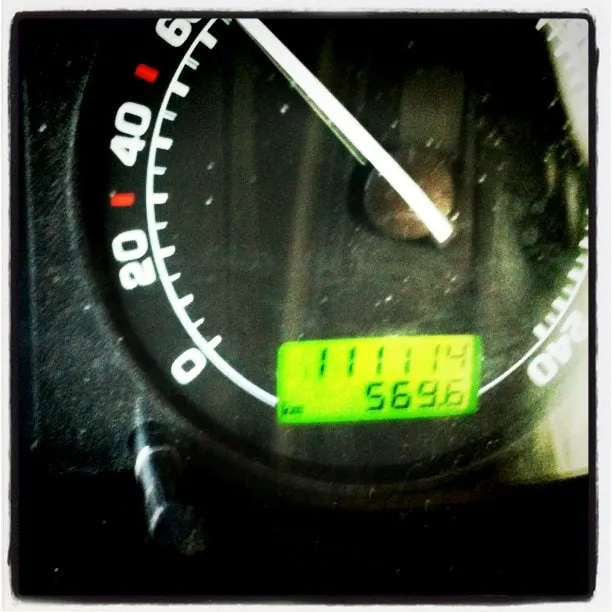 Close-up of a car speedometer with the digital odometer reading 111114 km.
