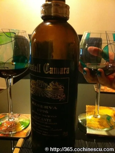 A bottle of Catel Camara Reserva 1996 wine sits between two glasses.