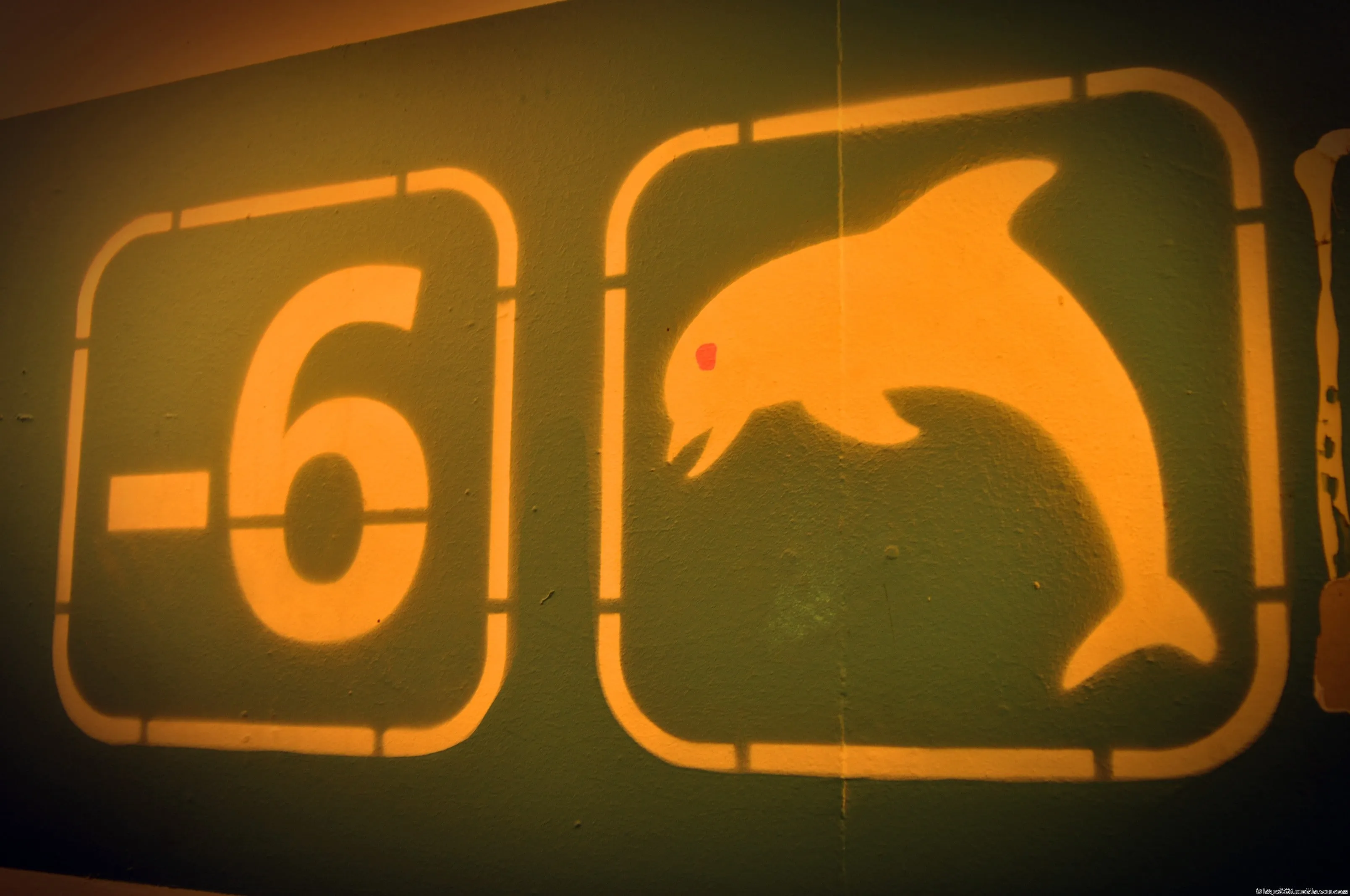 On the wall of an underground parking garage in Brussels, the minus-six marker appears next to the silhouette of a rabbit.