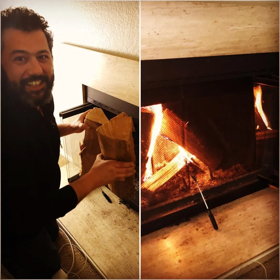 Side-by-side of a smiling bearded man holding firewood next to a lit fireplace with a poker on the hearth