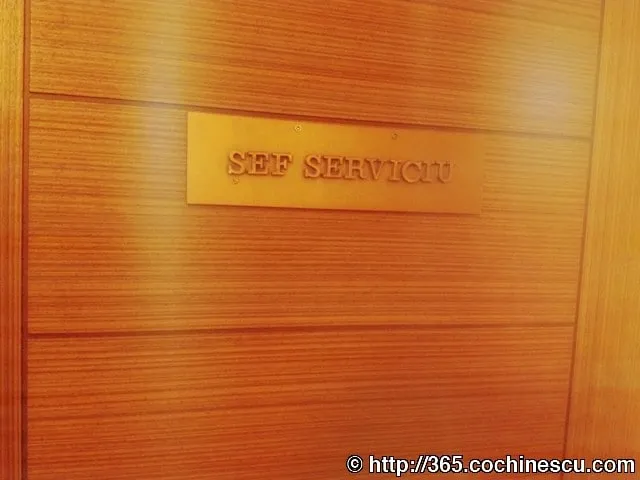 A plaque reading «DEPARTMENT HEAD» is mounted on a wooden door.