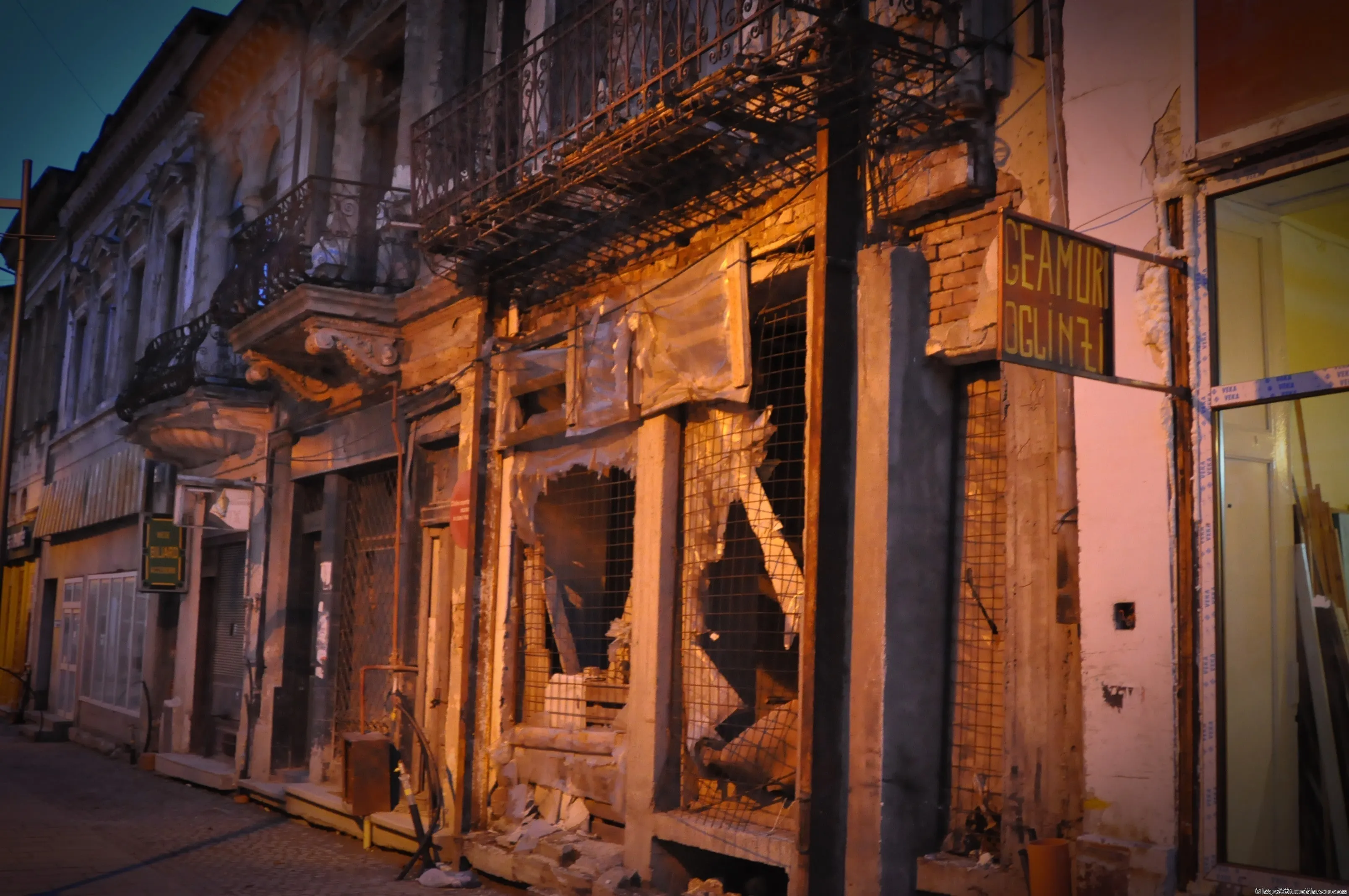 A run-down shop window and old balconies on a street in Lipscani, Bucharest.